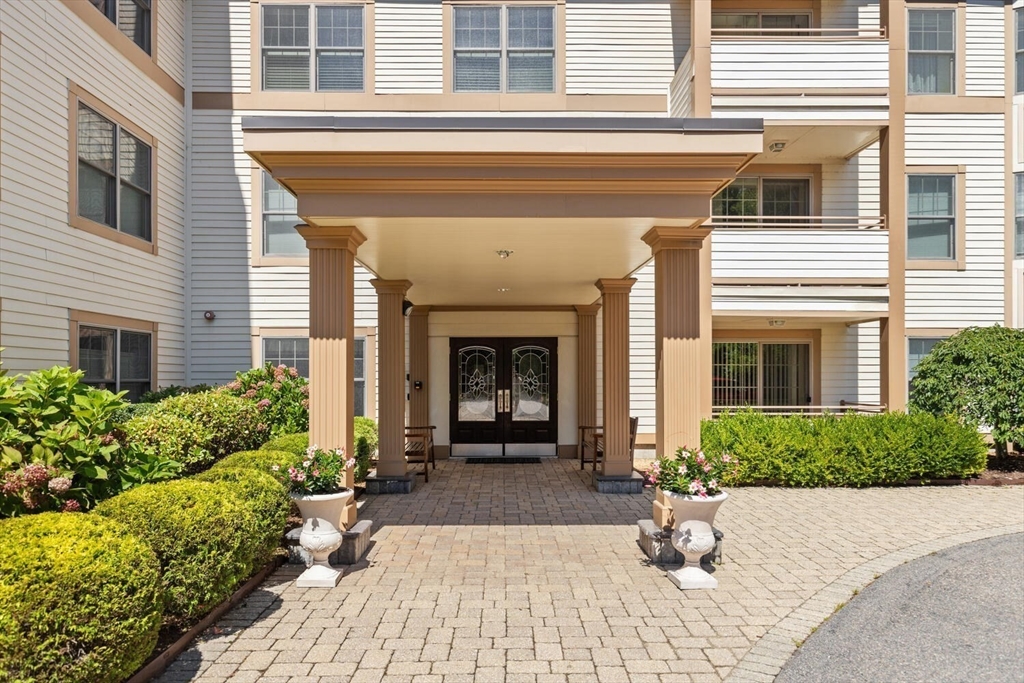 a view of a house with potted plants