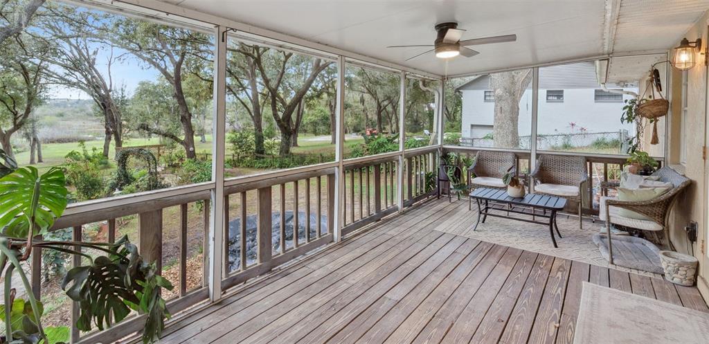 30911 Vista View Mount Dora, FL 32757 - Photo 30 of 54 a balcony with wooden floor and outdoor seating
