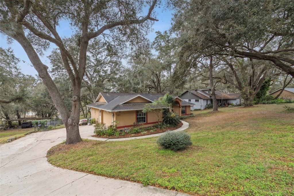 30911 Vista View Mount Dora, FL 32757 - Photo 10 of 54 a front view of a house with a yard garage and outdoor seating