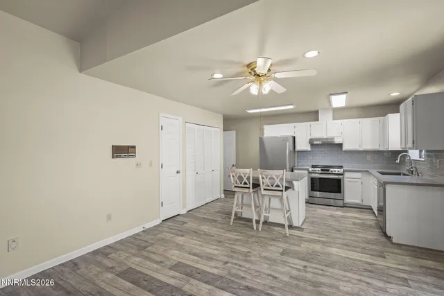 a view of a kitchen with a stove cabinets
