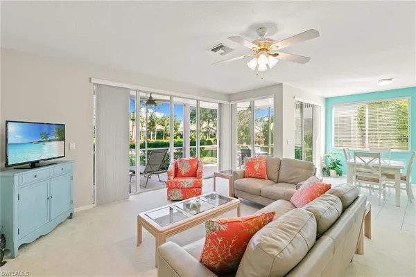 a living room with furniture and large windows