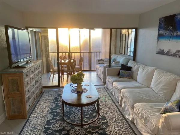 a living room with furniture fireplace and flat screen tv