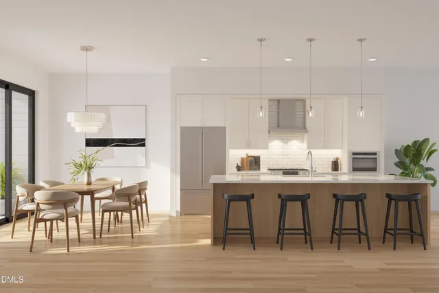 a large kitchen with cabinets table and chairs