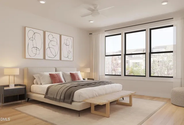 a bedroom with a bed and a large window