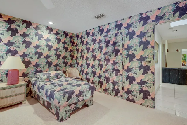 a bedroom with a bed and a curtain