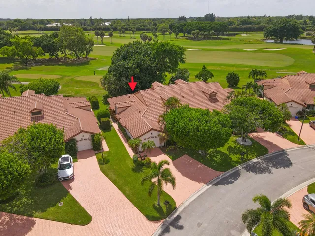 an aerial view of a house with garden space and ocean view