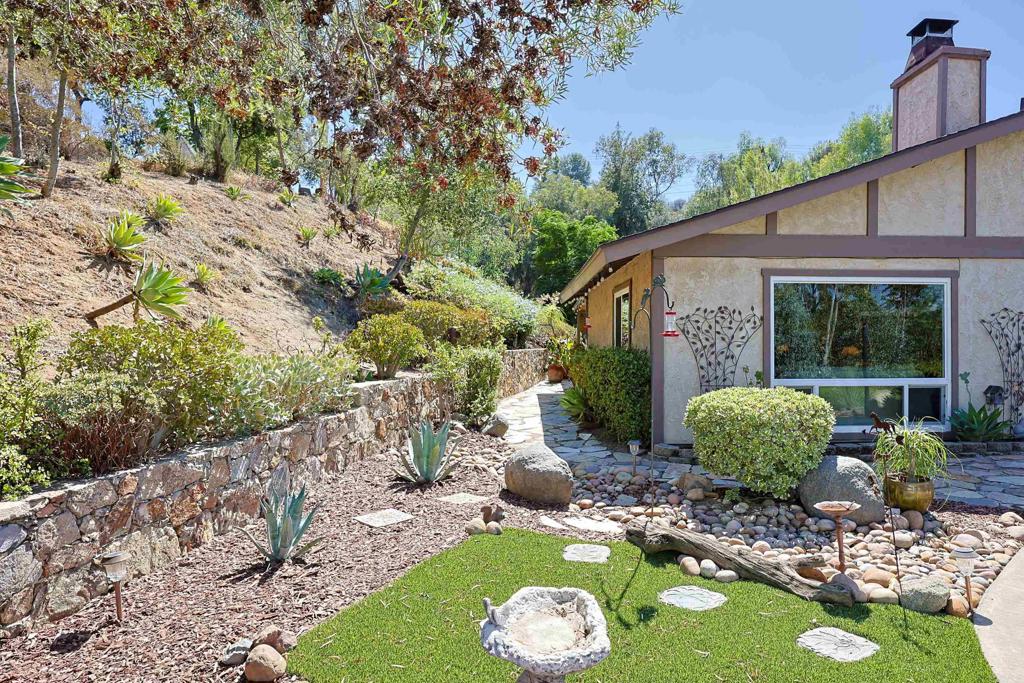 740 South Grade Road Alpine, CA 91901 - Photo 2 of 31 a view of a backyard with table and chairs potted plants and large tree