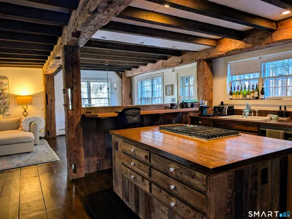 a kitchen with a stove sink and cabinets
