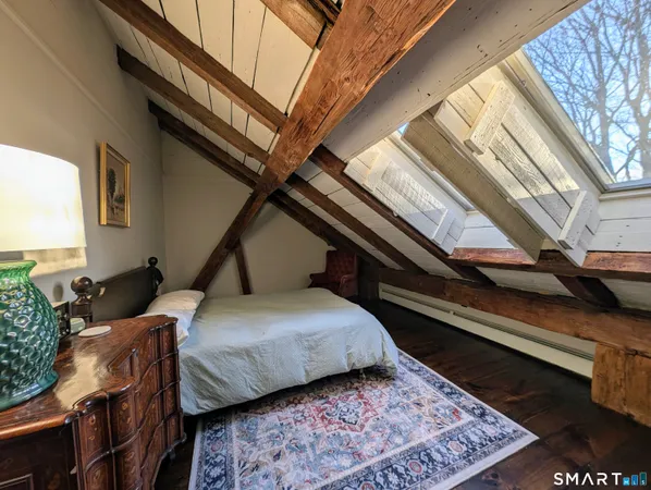 a bedroom with furniture and a rug