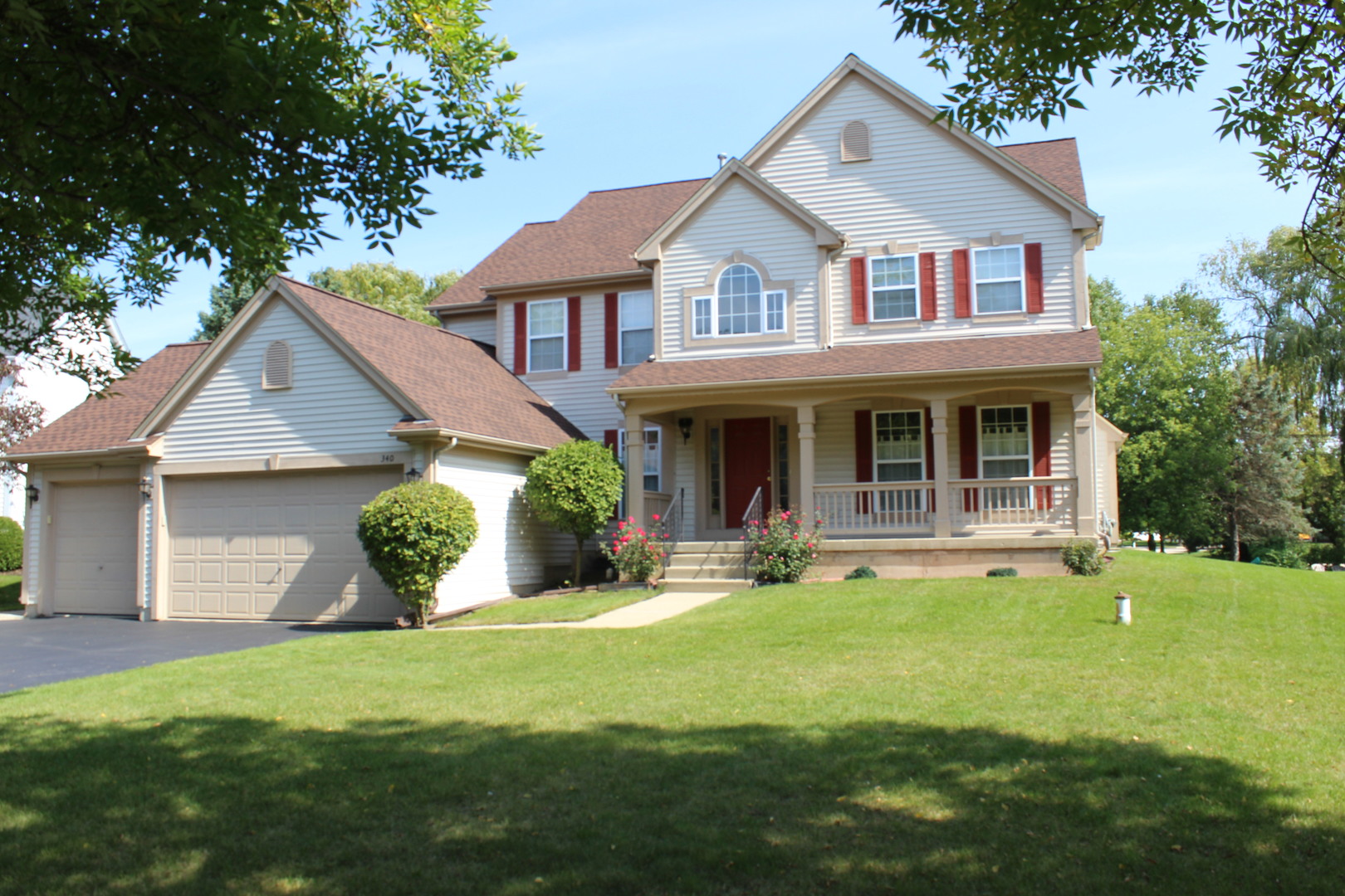 a front view of a house with a garden and porch