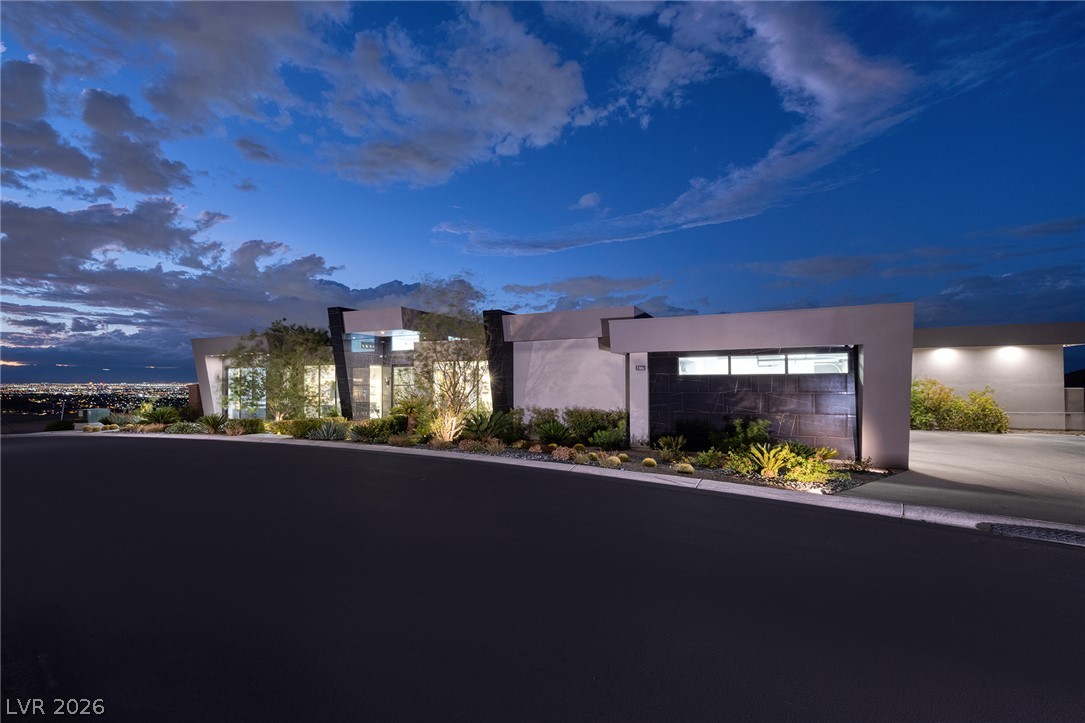 611 Cityview Ridge Drive Henderson, NV 89012 - Photo 4 of 66 Dramatic contemporary elevation overlooking sparkling city light views under a twilight sky.