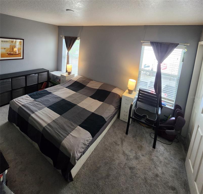 2013 Sea Front Court Clearwater, FL 33763 - Photo 14 of 17 a bedroom with a bed a lamp on desk and a window