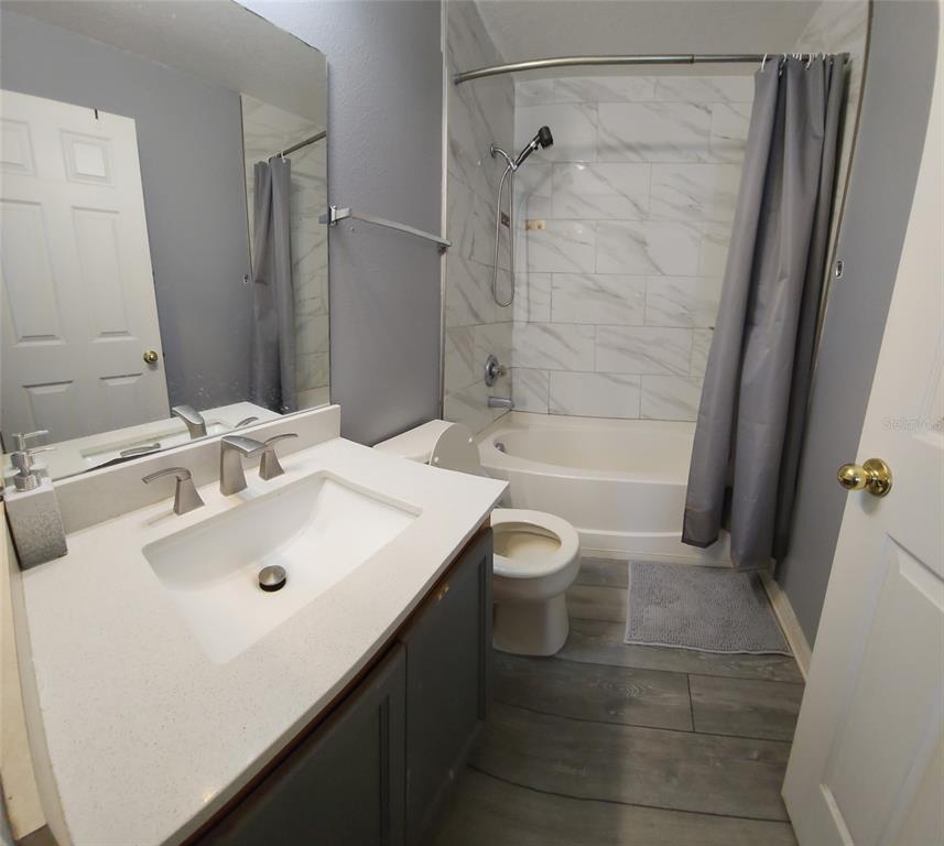 2013 Sea Front Court Clearwater, FL 33763 - Photo 15 of 17 a bathroom with a sink a toilet and shower