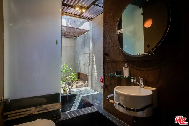 a view of a chair and table in backyard of the house