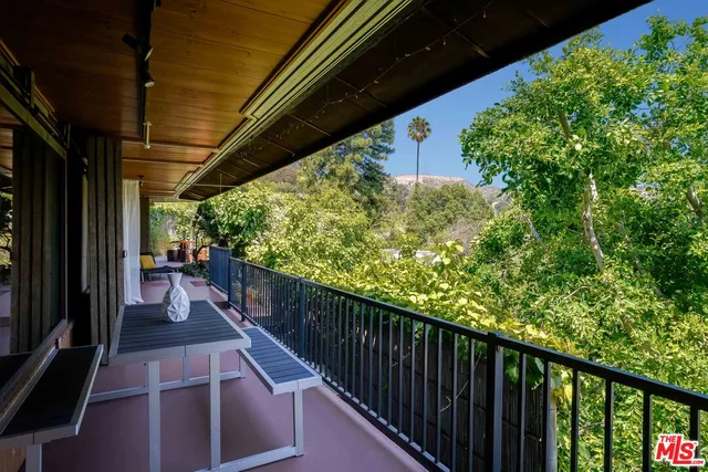 a view of a porch with furniture and a gate