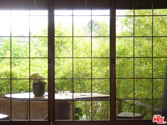 a bedroom with furniture and large windows