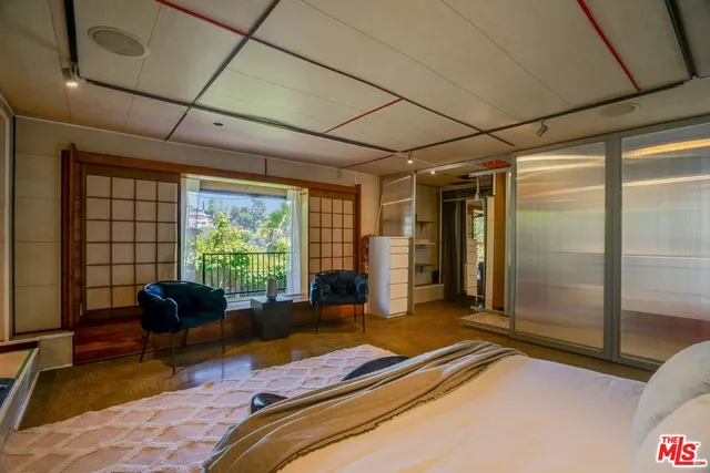 a bedroom with bed and a couch