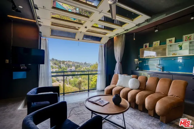 a outdoor living space with furniture and a floor to ceiling window