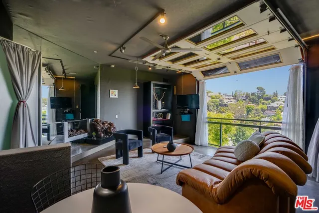 a outdoor living room with furniture and a large window
