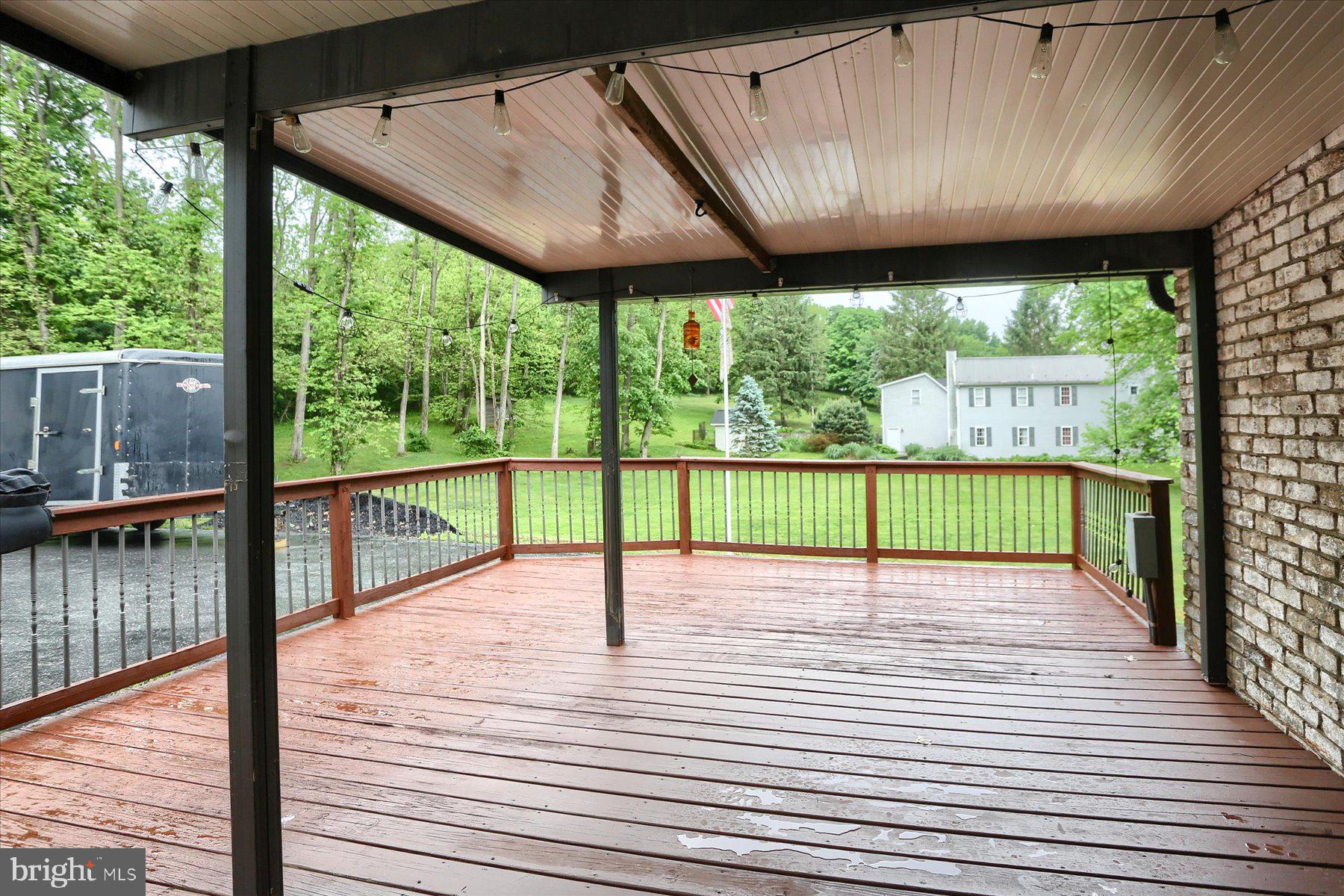 12 South Ridge Road Boiling Springs, PA 17007 - Photo 36 of 39 a view of a deck with wooden floor and roof with a garden view