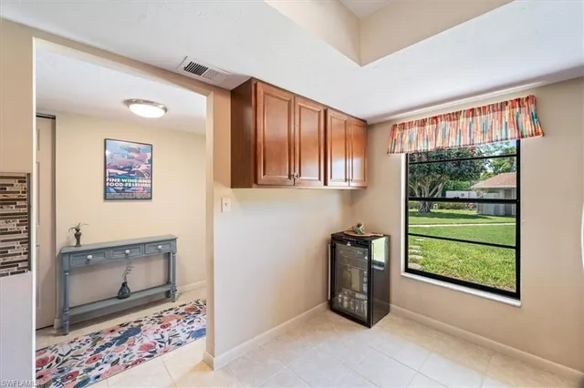 a living room with furniture a ceiling fan and a rug