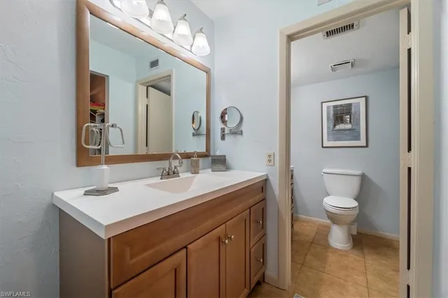 a bedroom with two beds and a chandelier
