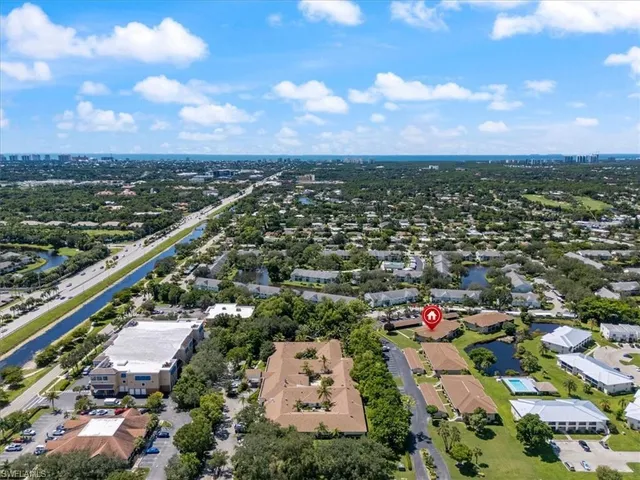 a view of a park with a house in the background