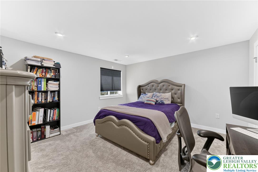 3952 Orth Street Bethlehem, PA 18020 - Photo 45 of 60 Recessed lighting illuminates a comfortable bedroom with soft carpeting and a window offering natural light.