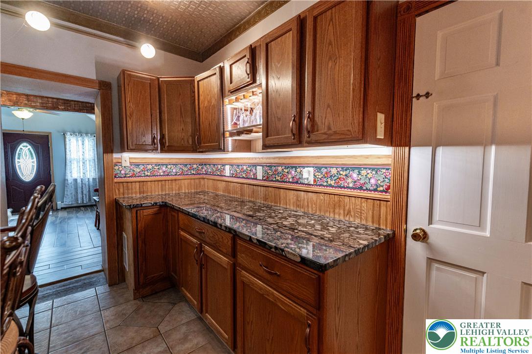 2485 Hieter Road Quakertown, PA 18951 - Photo 16 of 97 Rich wood cabinetry and gleaming granite counters define this inviting kitchen space.
