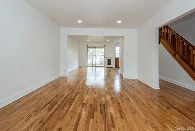 a view of a room with wooden floor and staircase