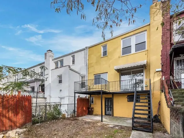 a view of a kitchen with a sink and an empty room