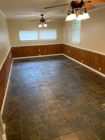 a view of a room with a window and a chandelier