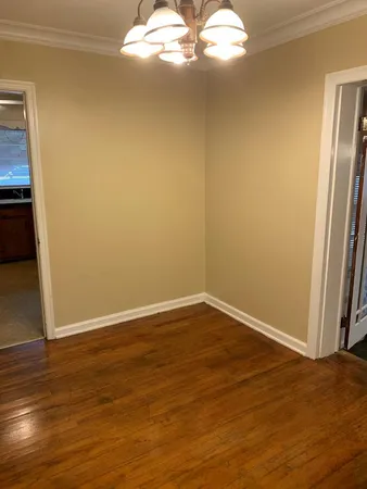a view of a big room with wooden floor and windows in it