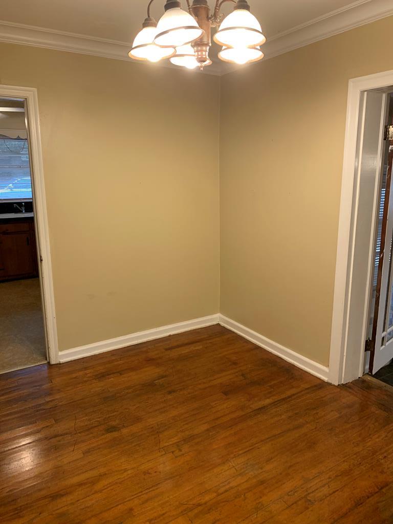 5820 Dearborn Avenue Columbus, GA 31909 - Photo 8 of 8 a view of a big room with wooden floor and windows in it