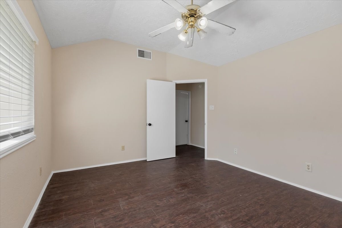 6022 Sean Court Humble, TX 77346 - Photo 11 of 18 an empty room with a chandelier fan and windows