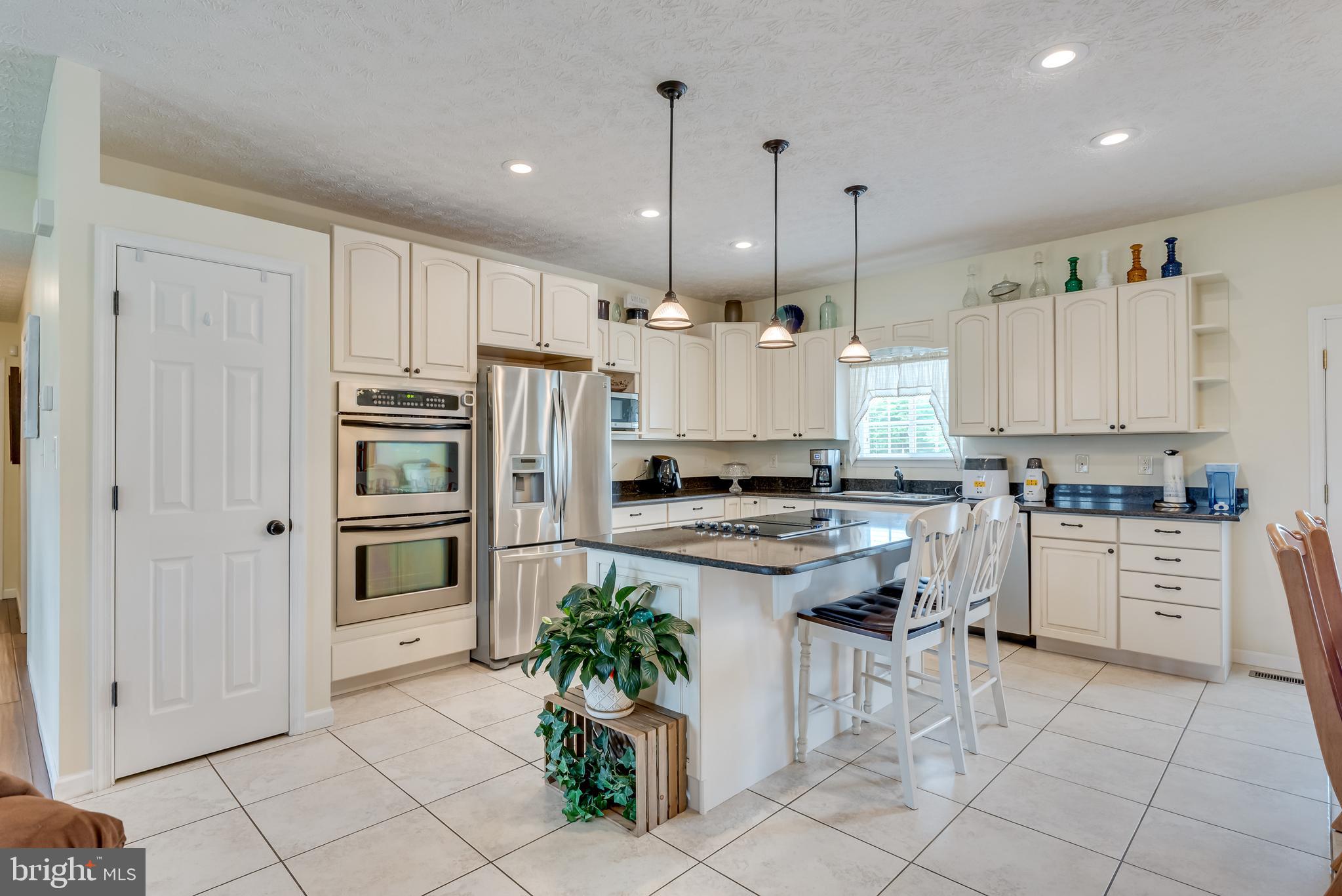 61 Torytown Road Bunker Hill, WV 25413 - Photo 13 of 57 Bright kitchen has a ceramic tile floor and pantry