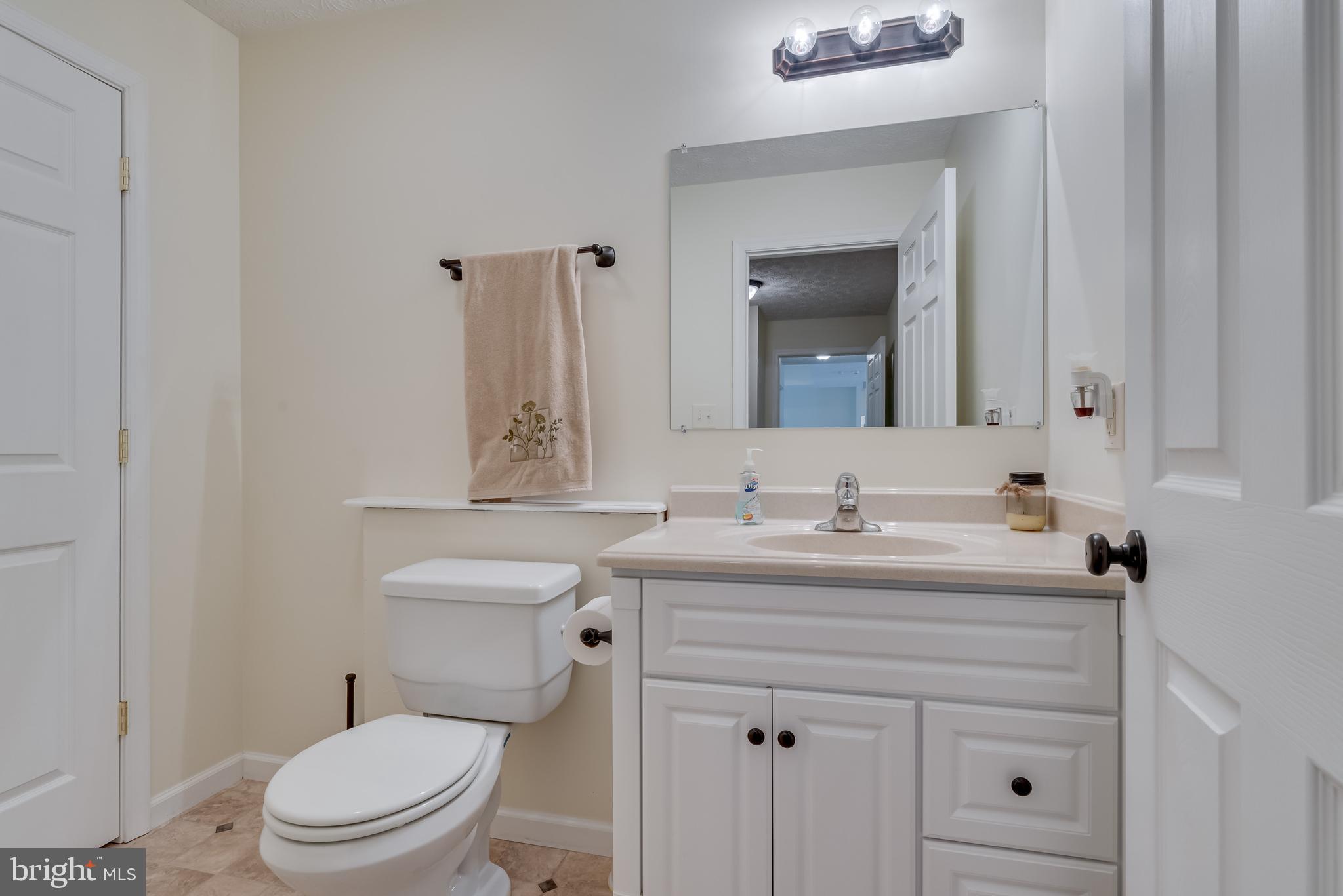 61 Torytown Road Bunker Hill, WV 25413 - Photo 22 of 57 1/2 bath has vinyl floors and a single bowl vanity