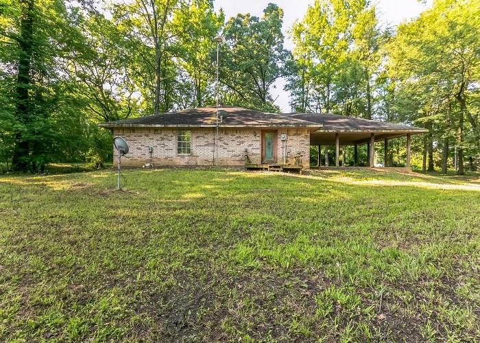 75 County Road 4235 Mount Pleasant, TX 75455 - Photo 1 of 1 a big white house with a big yard and large trees