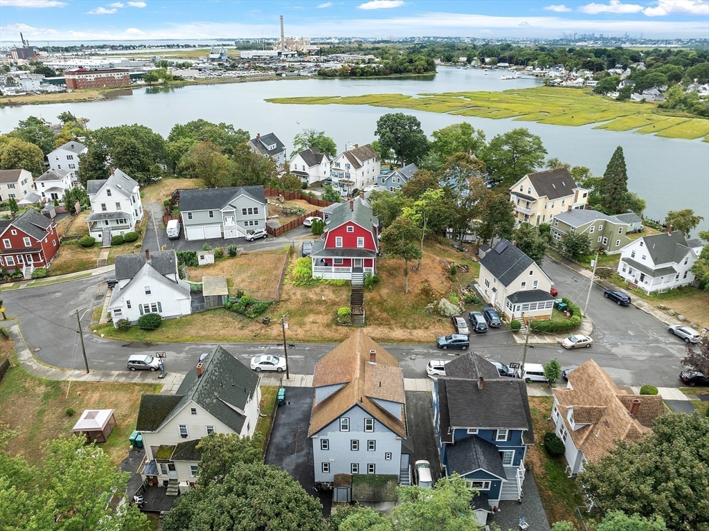 an aerial view of residential building with outdoor space and ocean view