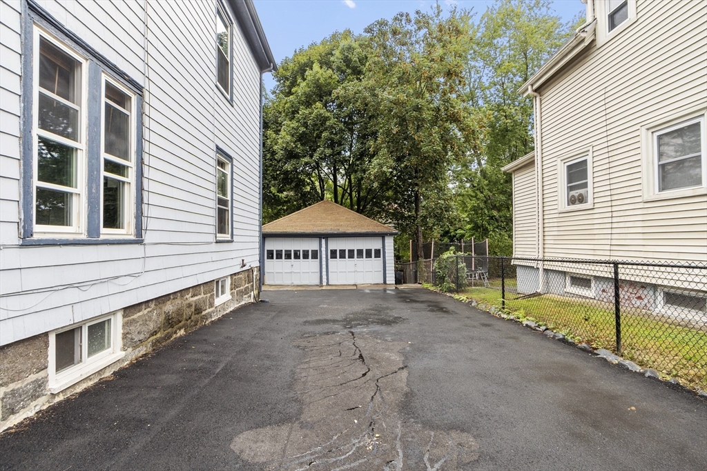 73 Dearborn Avenue, Unit 1 Lynn, MA 01905 - Photo 15 of 16 a view of a house with a yard and garage