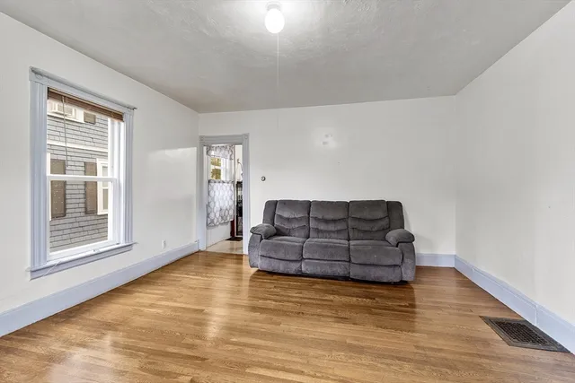 a living room with furniture and large window