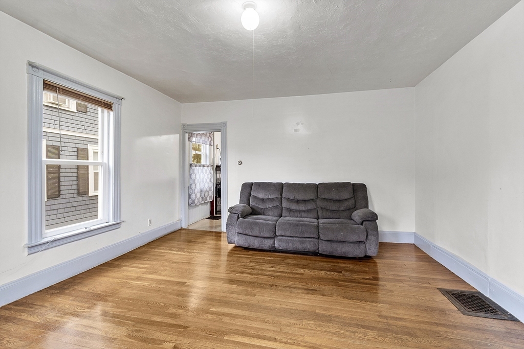 73 Dearborn Avenue, Unit 1 Lynn, MA 01905 - Photo 3 of 16 a living room with furniture and large window