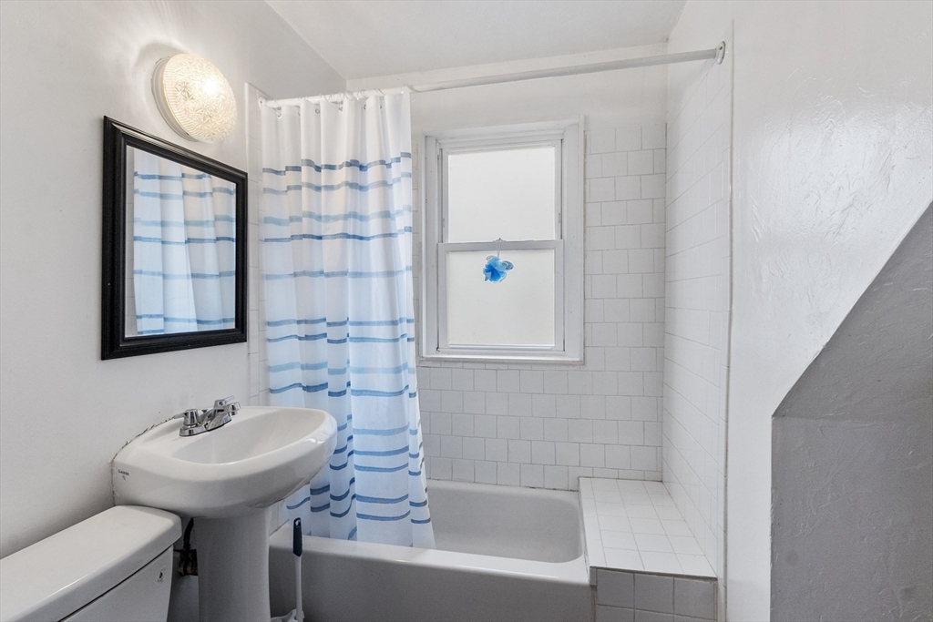 73 Dearborn Avenue, Unit 1 Lynn, MA 01905 - Photo 4 of 16 a bathroom with a sink a toilet and shower