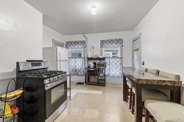 a kitchen with stainless steel appliances a stove a sink and cabinets