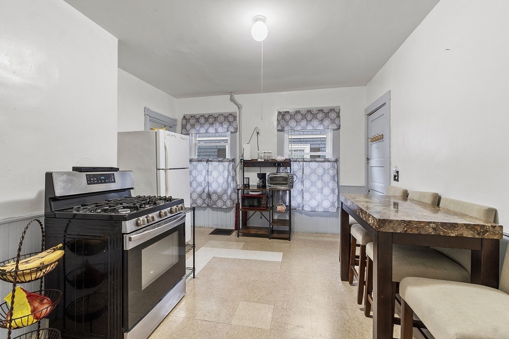 73 Dearborn Avenue, Unit 1 Lynn, MA 01905 - Photo 5 of 16 a kitchen with stainless steel appliances a stove a sink and cabinets