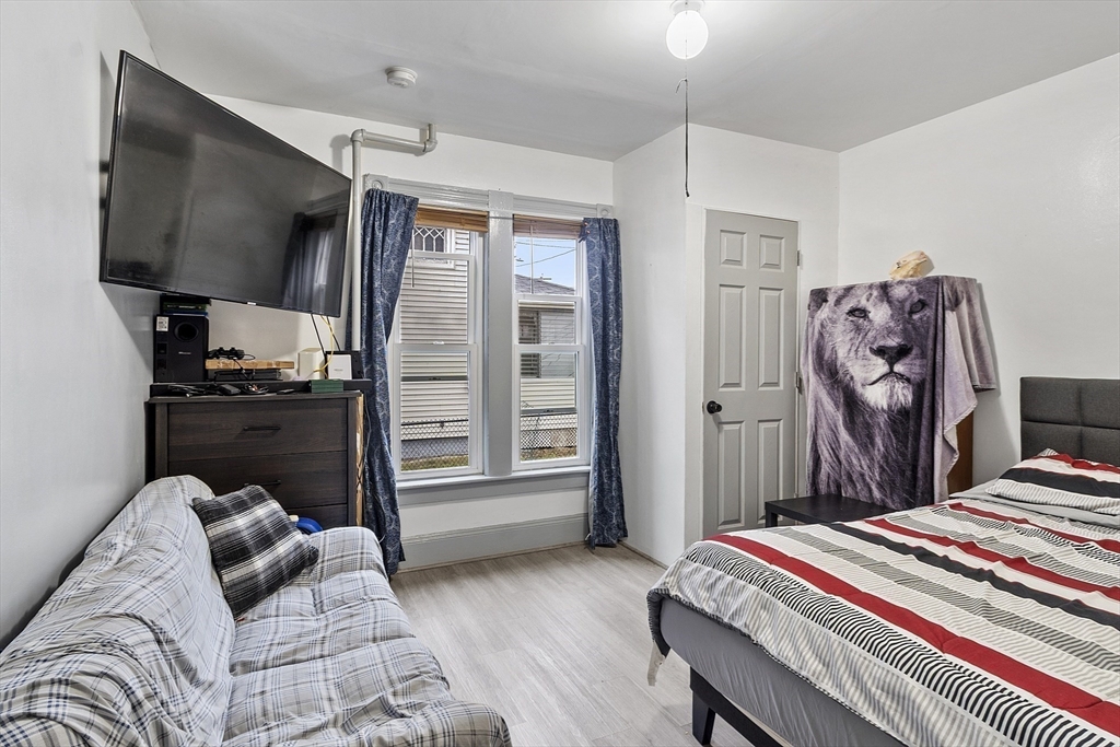 73 Dearborn Avenue, Unit 1 Lynn, MA 01905 - Photo 6 of 16 a bed room with a bed tv and a chair