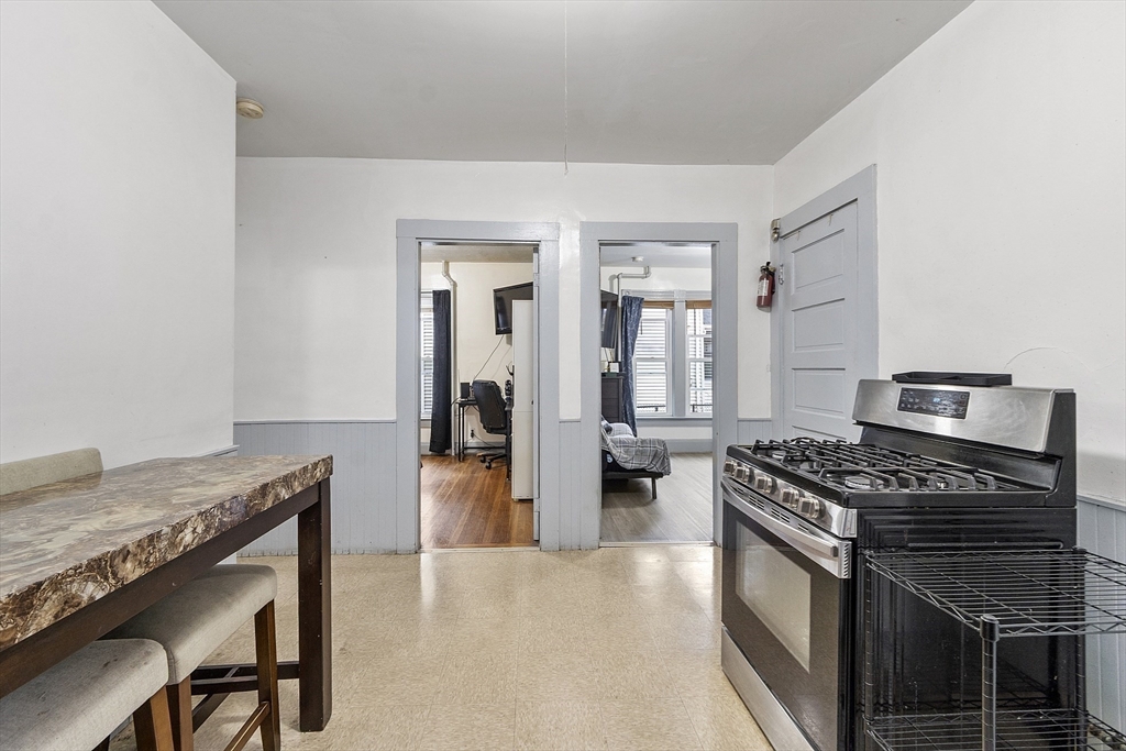 73 Dearborn Avenue, Unit 1 Lynn, MA 01905 - Photo 10 of 16 a kitchen with stainless steel appliances granite countertop a stove and a refrigerator