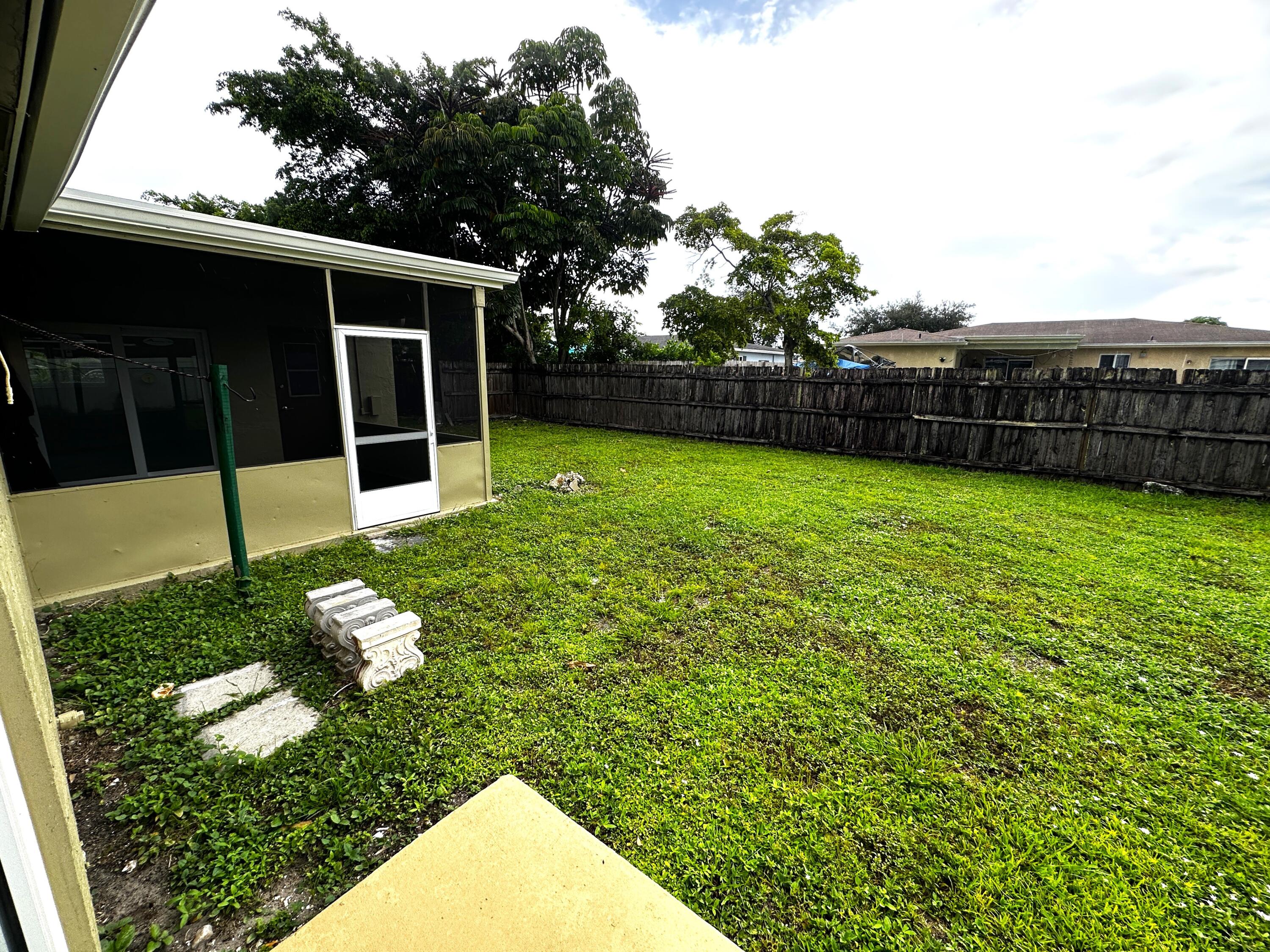 11150 Delta Circle Boca Raton, FL 33428 - Photo 15 of 17 a view of a backyard with potted plants and large tree