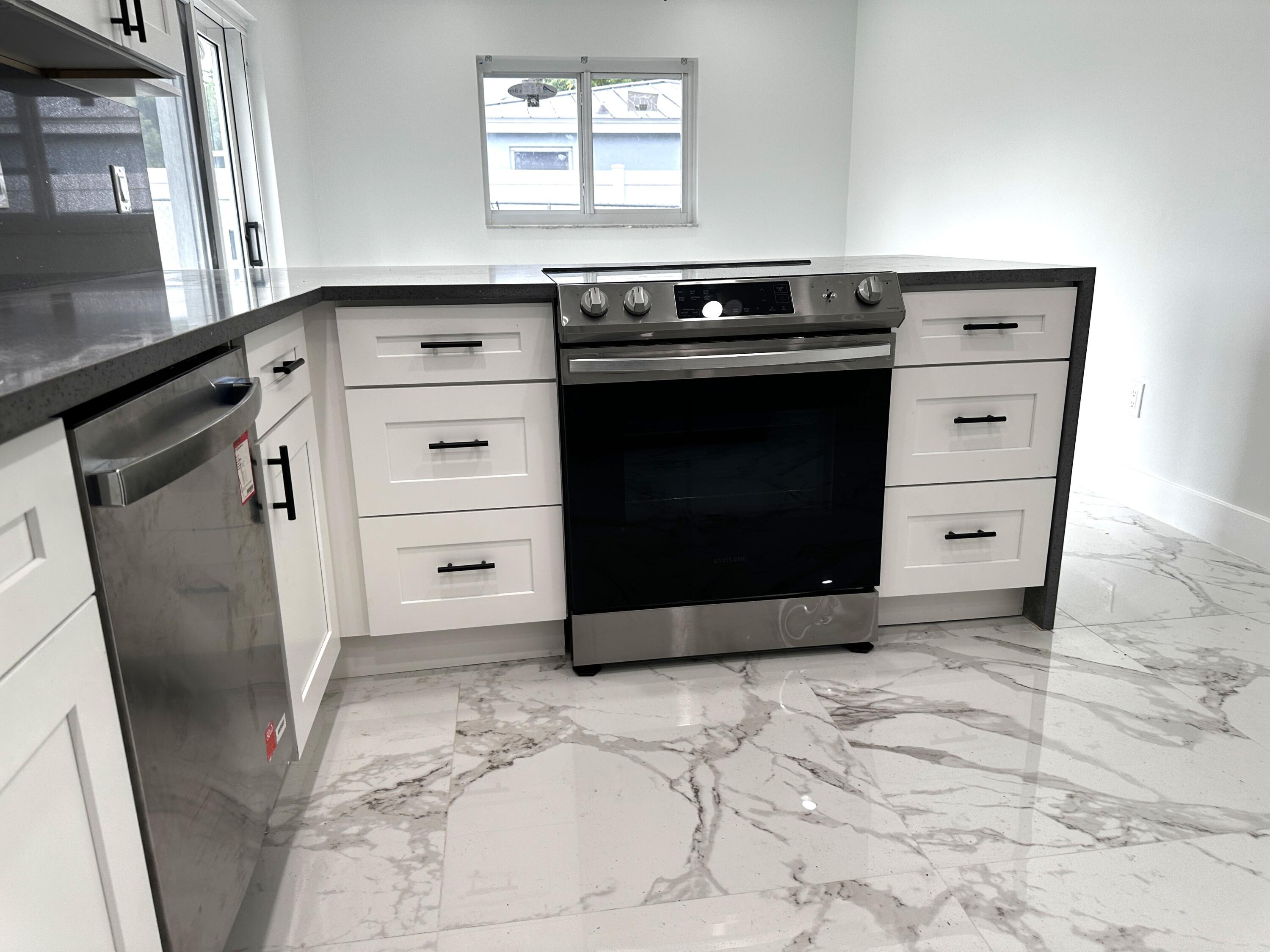 11150 Delta Circle Boca Raton, FL 33428 - Photo 5 of 17 a kitchen with a stove and a refrigerator