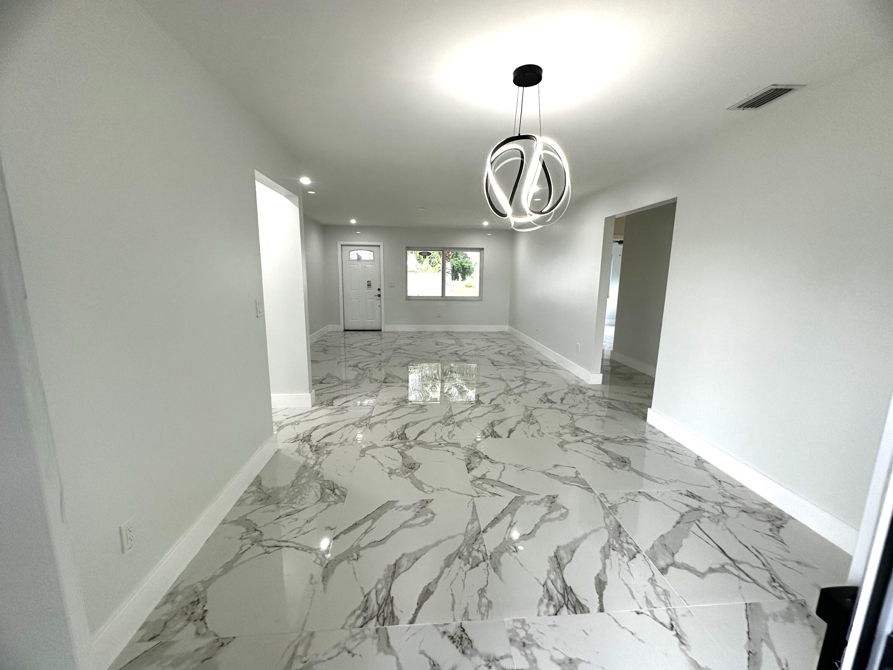 11150 Delta Circle Boca Raton, FL 33428 - Photo 6 of 17 a view of a hallway with wooden floor